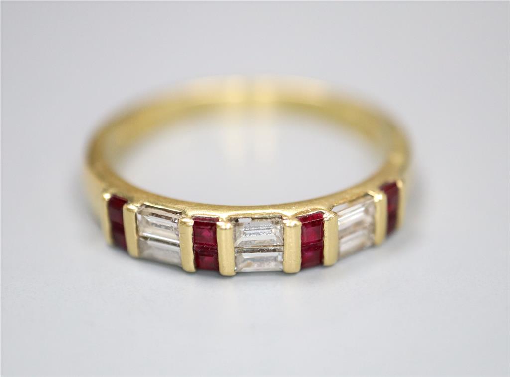 A modern 18ct gold, square cut ruby and baguette cut diamond set half hoop ring, size Q, gross 3.6 grams.